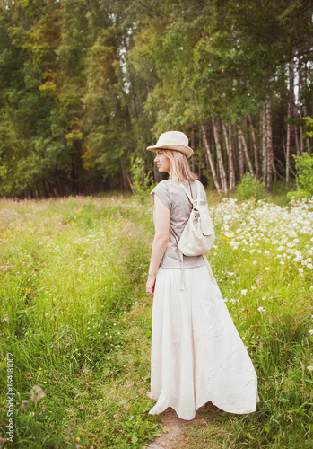 Beautiful woman in long dress on the summer meadow © darkbird