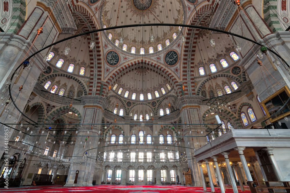 Fatih Mosque, a public Ottoman mosque in the Fatih district of Istanbul, Turkey, with a huge decorated domes & many colored stained glass windows