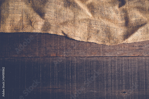 Wood table with old sackcloth burlap tablecloth texture with filter effect retro vintage style photo