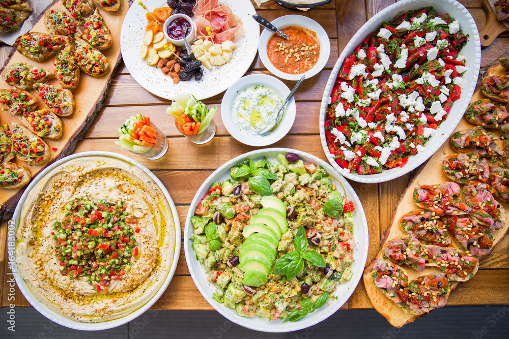 wooden table on the street in a cafe with food, Outdoor terrace concept of a buffet table, catering. wooden table on the street in a cafe with food, Outdoor terrace concept of a buffet table, catering.
