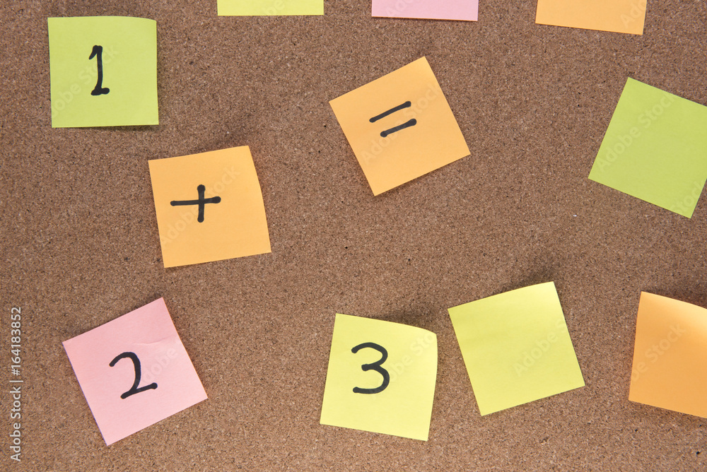 Multiple multi-coloured post it notes on a wooden background Multiple multi-coloured post it notes on a wooden background
