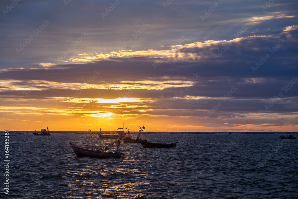 silhouette fishing boats on the sea at sunset