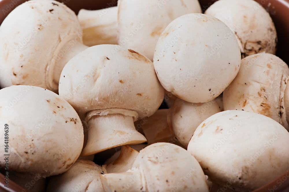 Mushrooms champignons on an old wooden background. Mushrooms champignons on an old wooden background.