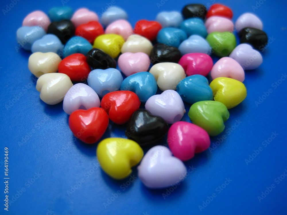 Many multi-colored beads in the shape of heart closeup Many multi-colored beads in the shape of heart closeup