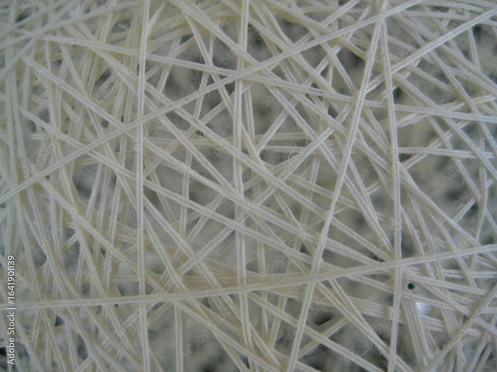 Interlacing  of a white thread, close-up