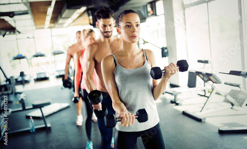 Group of people have workout in gym
