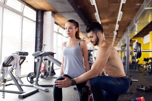 Young attractive woman doing exercises in gym