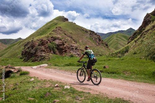A cyclist is traveling in the mountains