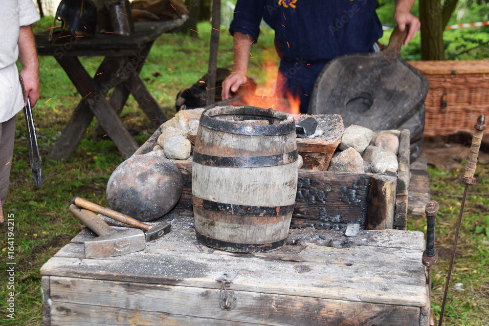 Blacksmith when working with a hammer in the open air Blacksmith when working with a hammer in the open air
