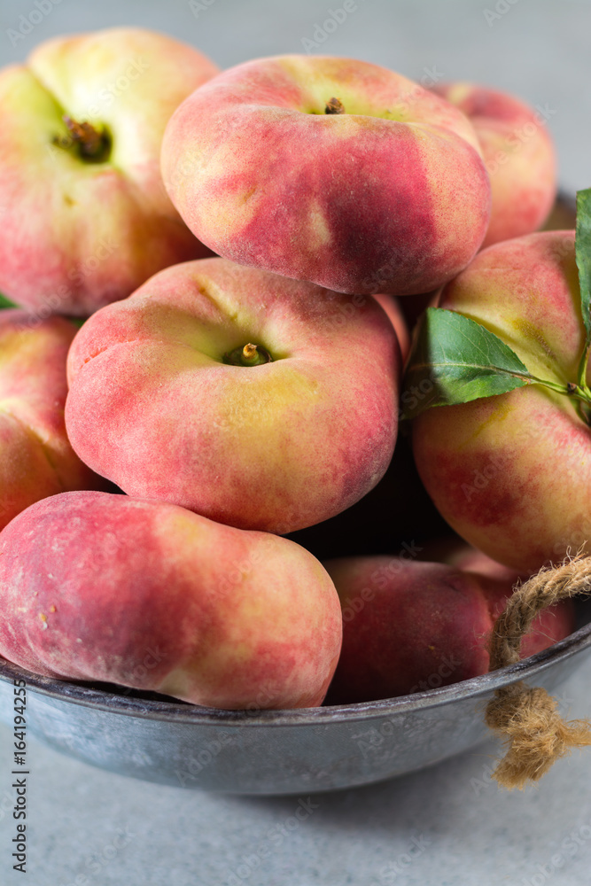 Fresh ripe chinese flat saturn peaches with leaves Fresh ripe chinese flat saturn peaches with leaves