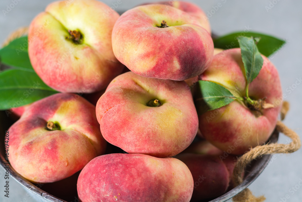 Fresh ripe chinese flat saturn peaches with leaves Fresh ripe chinese flat saturn peaches with leaves