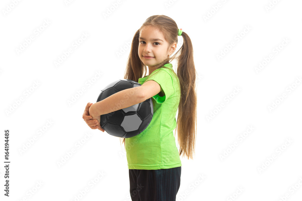 cheerful little girl with soccer ball in hands looking at the camera cheerful little girl with soccer ball in hands looking at the camera