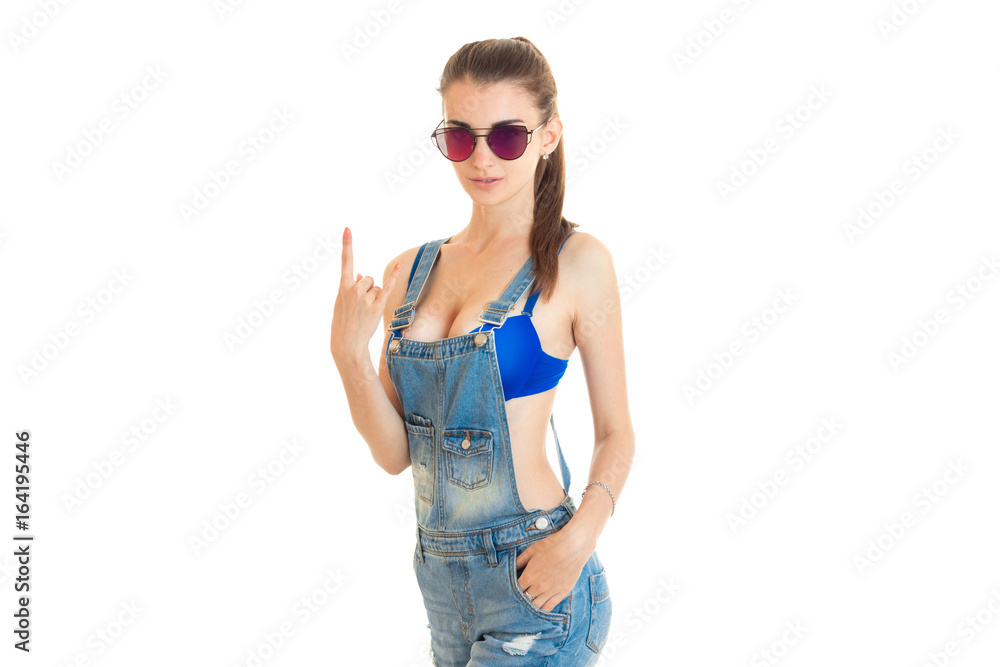 beautiful young girl in jeans overall and blue bra with big round silicon  breasts posing on camera Stock-Foto | Adobe Stock