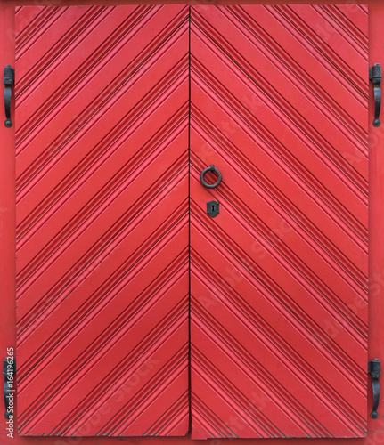 Old big red door with a lock photo