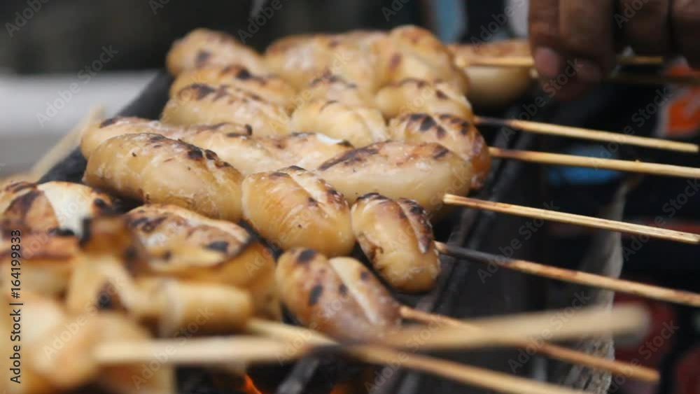 Preparing grilled squid, street food in Thailand. Preparing grilled squid, street food in Thailand.