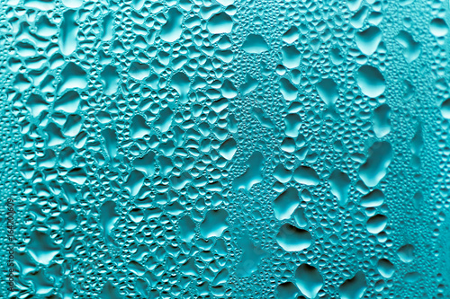 Background of water drops on the some surface in blue colors