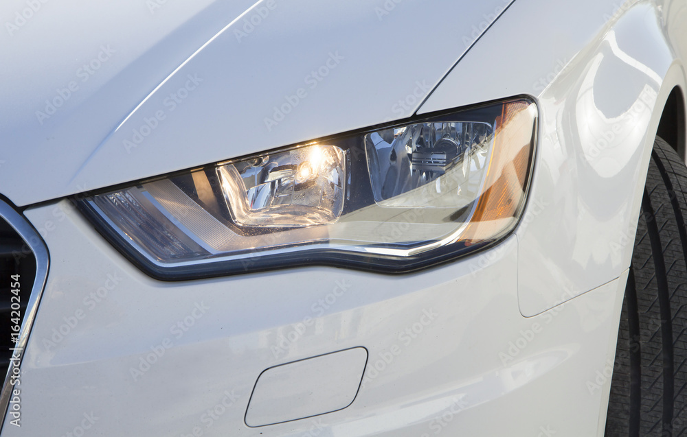 White car headlight close up, beam - obrazy, fototapety, plakaty 