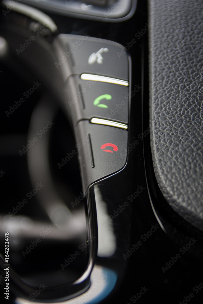 Obraz premium Phone, hands free console on vehicle's steering wheel