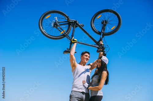 a young couple, travel by bicycle