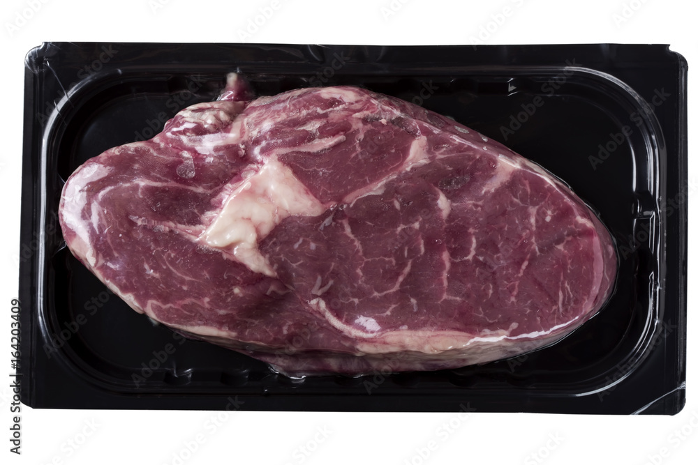 Raw rib eye steak in vacuum, isolated on white background