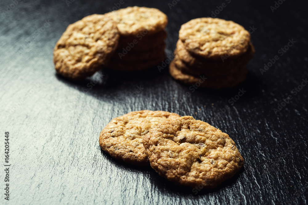 Biscuit sweet cookie background. Domestic stacked butter biscuit pattern concept,close up macro.Homemade cookies on wooden table.Cereal biscuits with the sesame,peanuts,sunflower and amaranth. Biscuit sweet cookie background. Domestic stacked butter biscuit pattern concept,close up macro.Homemade cookies on wooden table.Cereal biscuits with the sesame,peanuts,sunflower and amaranth.