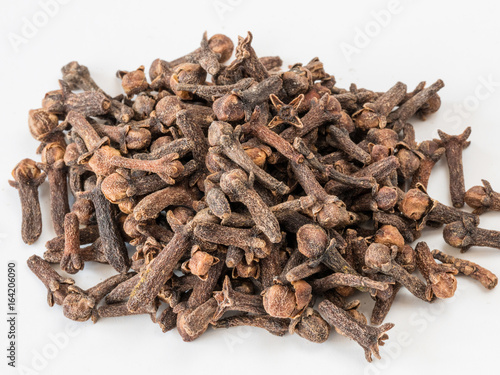 Clove spice. Carnation seasoning. A pile of carnations isolated on a white background. Natural spices