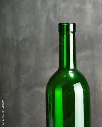 High wine glass made from green glass. No content. Side view. Low key.