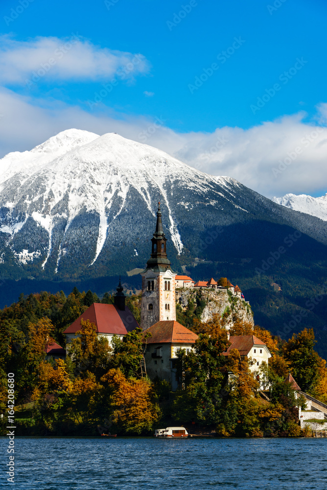 Bled lake with snow on the mountains in autumn