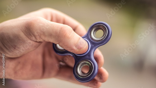 The hand holds the spinner