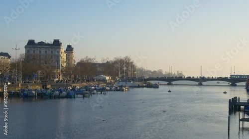 zurich sunset river yacht dock quaibrücke tram traffic bridge panorama 4k switzerland
 photo