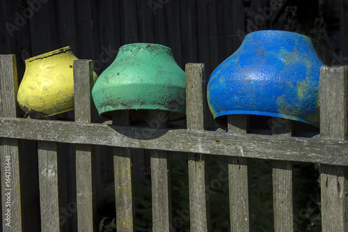 Bright pots on the fence