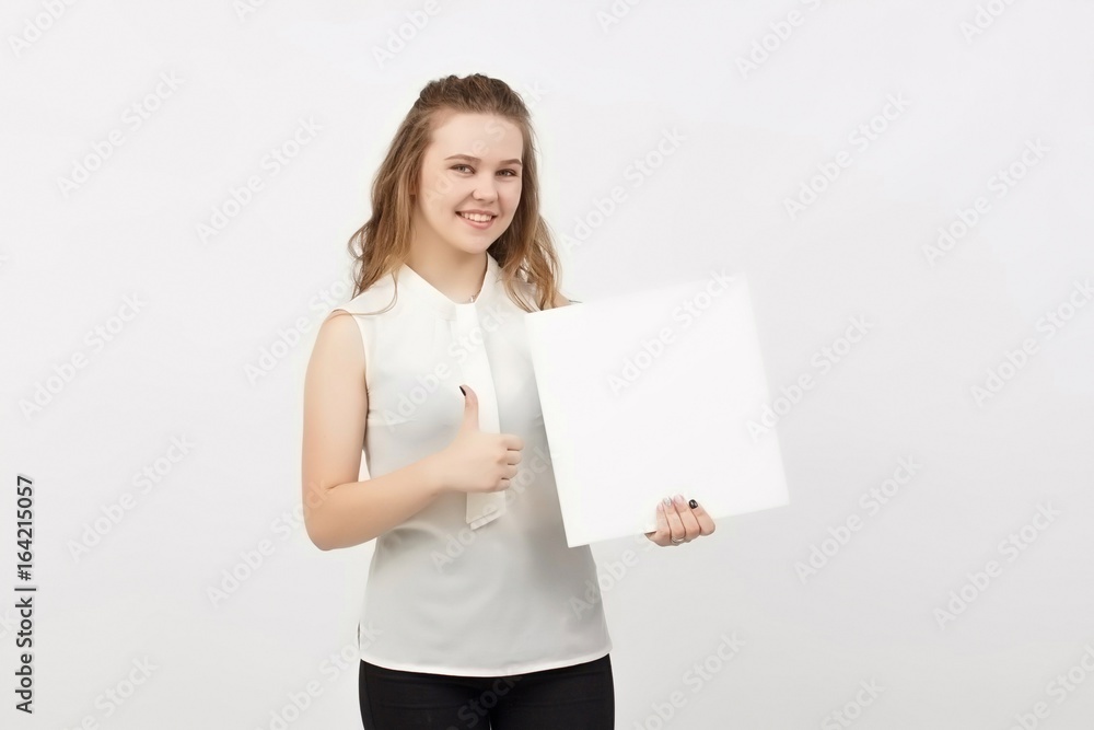 Young woman holding blank poster.Smiling woman sign board holding. Girl showing banner with copy space. Young woman holding blank poster.Smiling woman sign board holding. Girl showing banner with copy space.