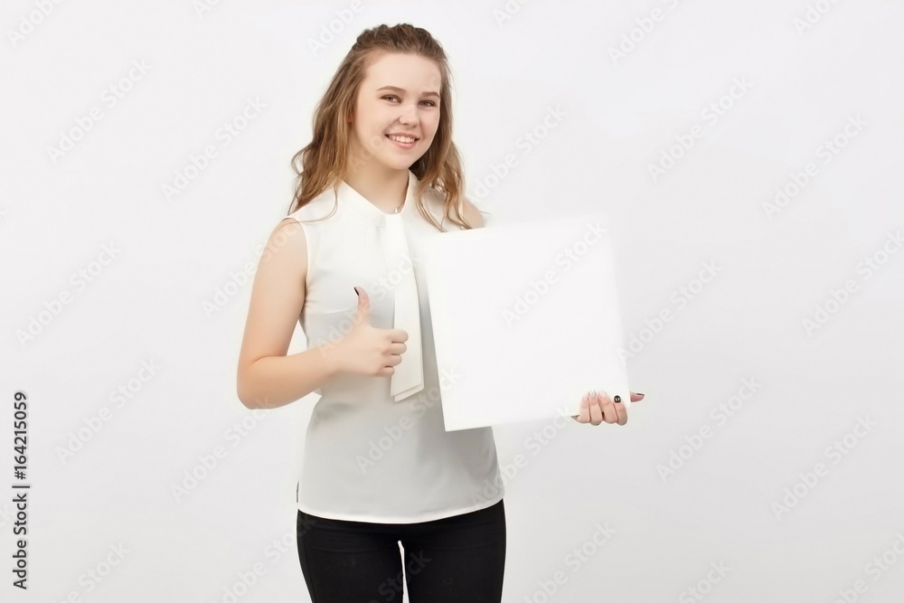 Young woman holding blank poster.Smiling woman sign board holding. Girl showing banner with copy space. Young woman holding blank poster.Smiling woman sign board holding. Girl showing banner with copy space.
