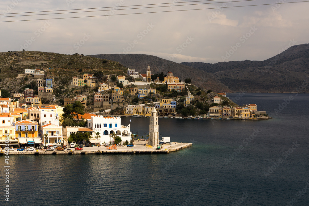Gulf in small typical island Symi with bright houses in Greece