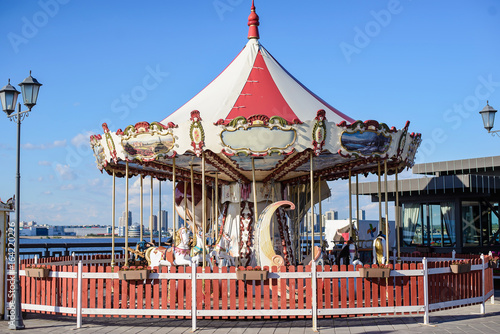 Children's carousel without people on a sunny summer day