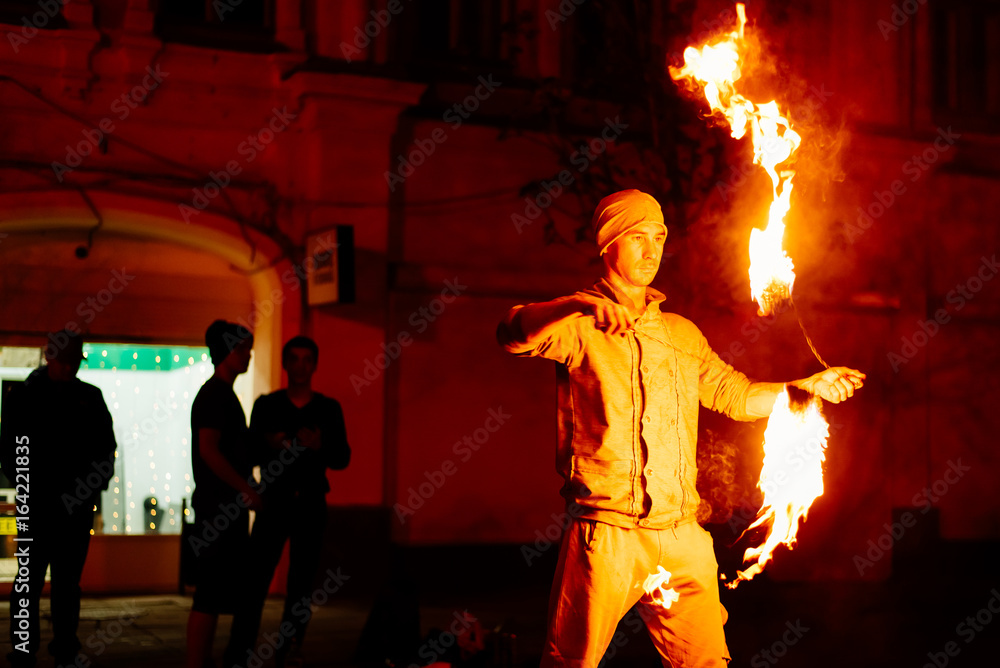 The guy on the street performs with fire torches The guy on the street performs with fire torches