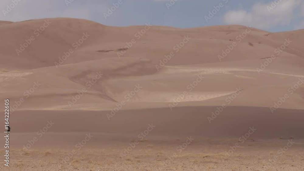 Great Sand Dunes National Park, Colorado, USA: Time-lapse of people climbing the giant dunes on a windy day Great Sand Dunes National Park, Colorado, USA: Time-lapse of people climbing the giant dunes on a windy day