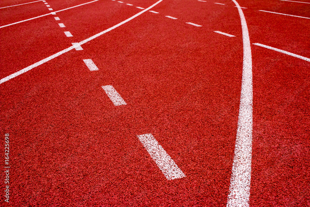 Red running track Synthetic rubber on the athletic stadium.