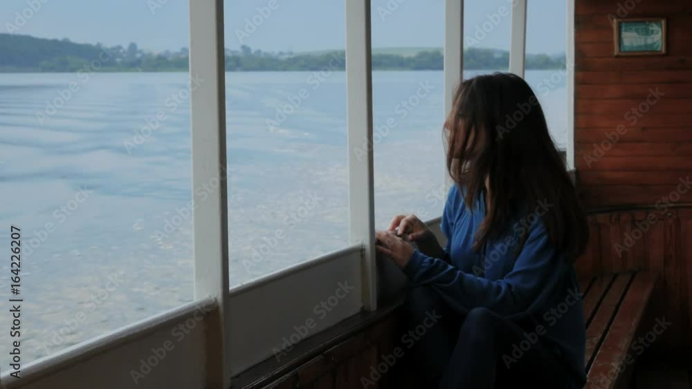 Travel, trip, vacation, tourist concept. Happy smiling young woman, female Asian mixed, traveling in a blue shirt, sailing on a passenger ship or boat in the summer on the lake sunset Travel, trip, vacation, tourist concept. Happy smiling young woman, female Asian mixed, traveling in a blue shirt, sailing on a passenger ship or boat in the summer on the lake sunset