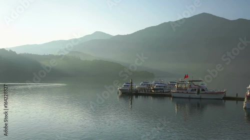 Panning right to Chaowu Pier with sunlight reflection on the lake, Sun moon lake, Taiwan  photo