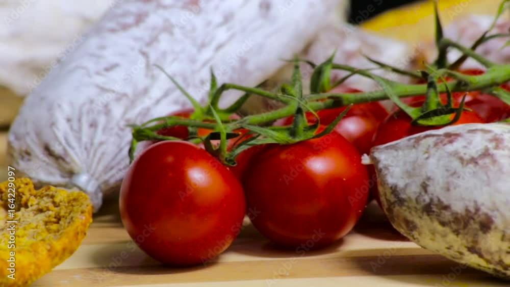 Chopping Board, delicious cured meat and pachino's tomatoes, bakery product Chopping Board, delicious cured meat and pachino's tomatoes, bakery product