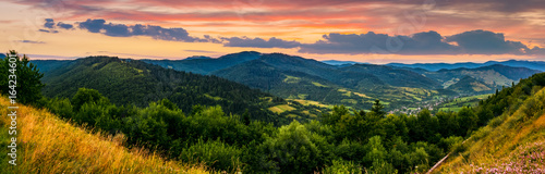 panorama of mountain ridge with peak at sunset