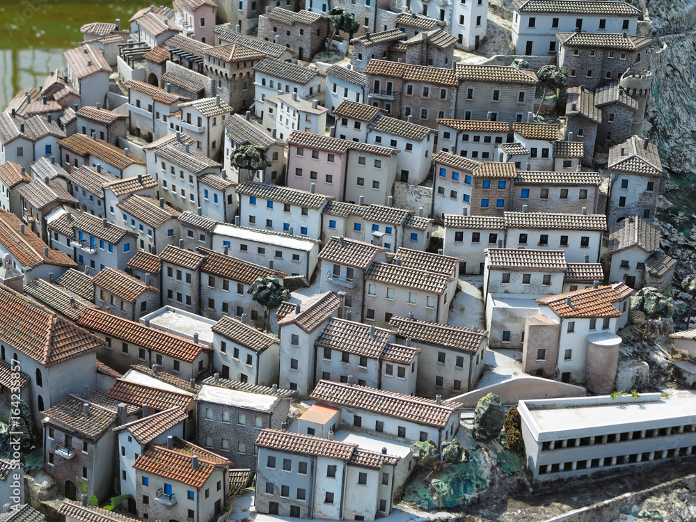 Concept of old medieval city, streets and small houses with tiled roofs