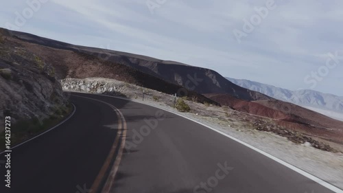 Driving USA: The road to Death Valley, California. Point of view car shot on highway descending into Death Valley National Park.