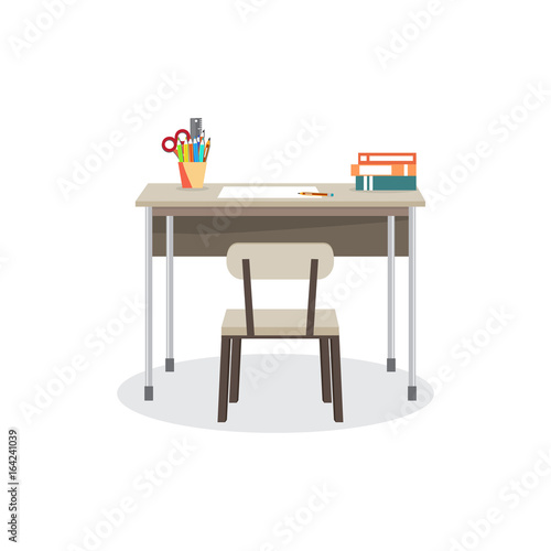 School desk with a chair. On the table are the school supplies. 