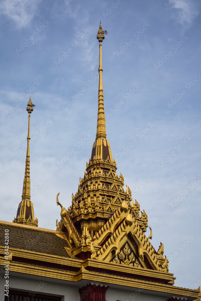 Fototapeta premium Loha Prasat Wat Ratchanatdaram in Bangkok Thailand which means iron castle or monastery is composes of five towers, of which the outer, middle and the center tower contain large black iron spires. 