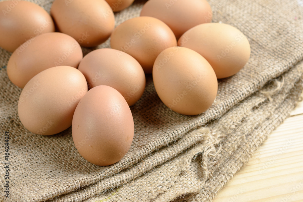 Pile of raw eggs on hemp sack Pile of raw eggs on hemp sack