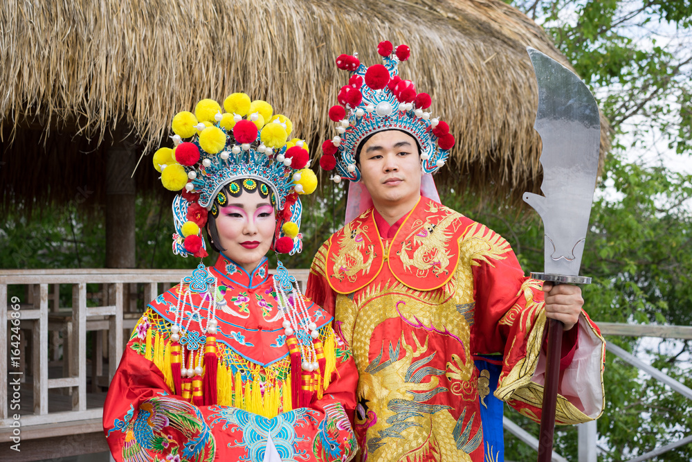 asian man and woman in traditional red chinese costumes
