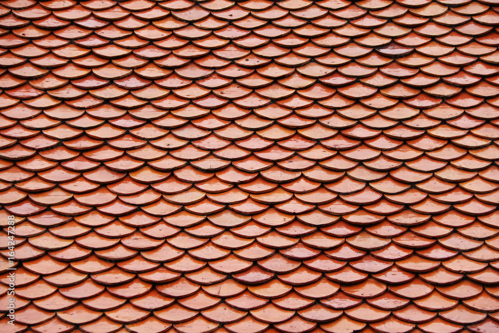 Pattern of Thai terracotta roof, red brown color. The pattern look like a fish scales. Pattern of Thai terracotta roof, red brown color. The pattern look like a fish scales.
