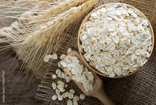 Oat in wooden spoon and bowl.
